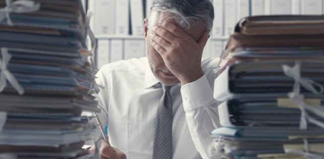 man overwhelmed by amount of work